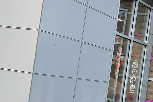 Modern building facade with entrance and signs