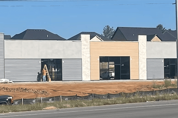 Commercial building construction site with excavator.